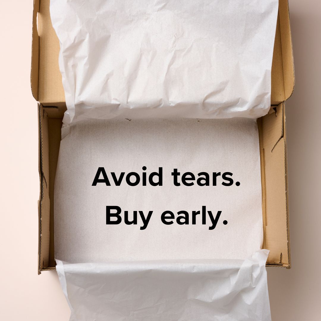 Photo of an empty gift box with wrapping tissue. Inside it are the words: 'Avoid tears. Buy early.' in black.