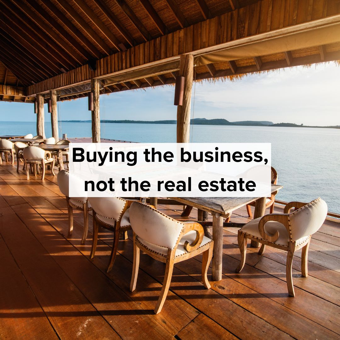 Title 'Buying the business, not the real estate' in black in the center. The image is of an open air restaurant in front of a body of water.
