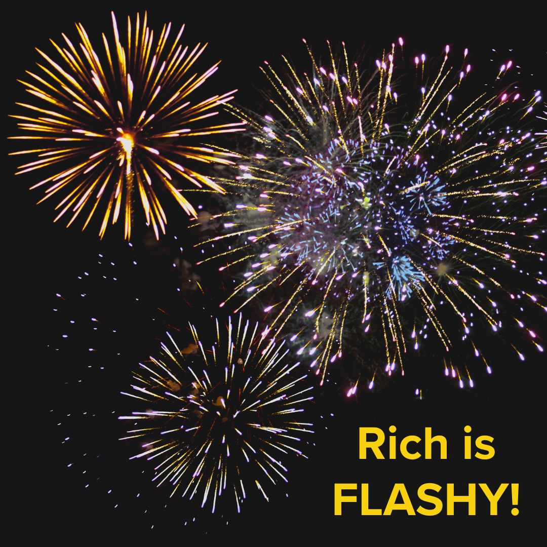 Title 'Rich is FLASHY!' in yellow in the bottom-right. The image is of many fireworks going off at once in a dark night sky.