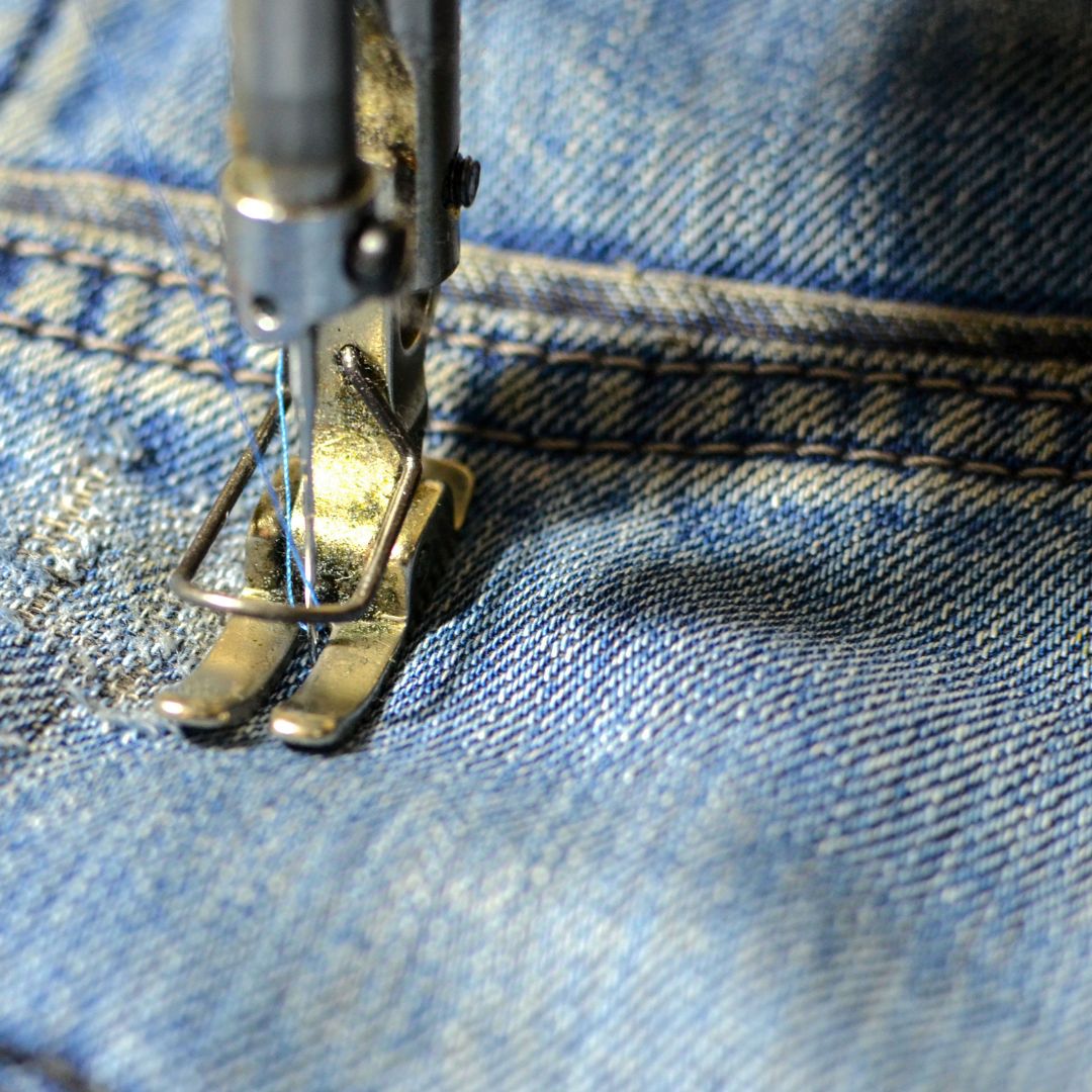 Sewing machine working on denim.