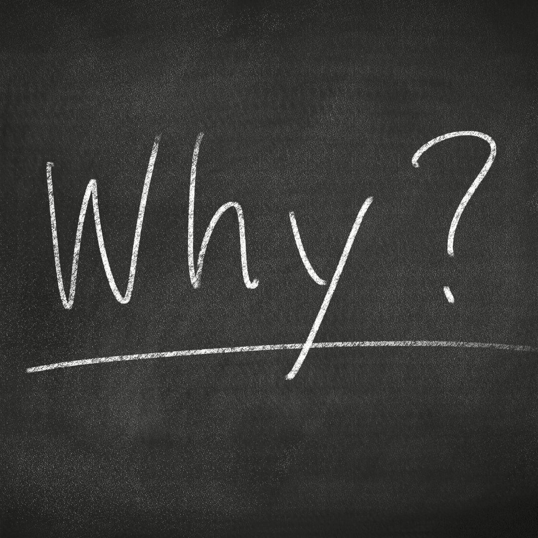 A black chalkboard with a single word written in chalk: 'Why?' It's also underlined in chalk.